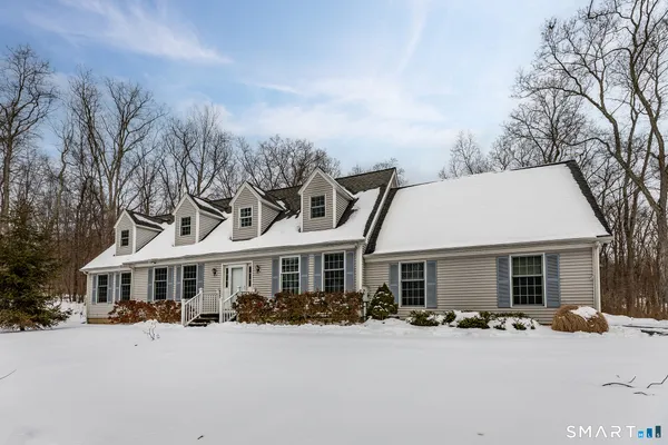 a front view of a house with yard patio and outdoor seating