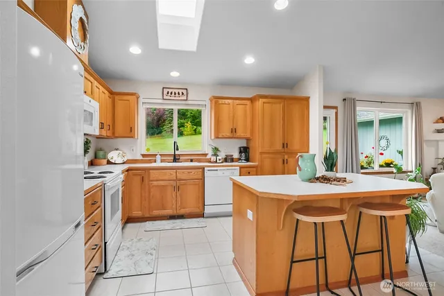 a kitchen with a stove a sink a refrigerator and a dining table