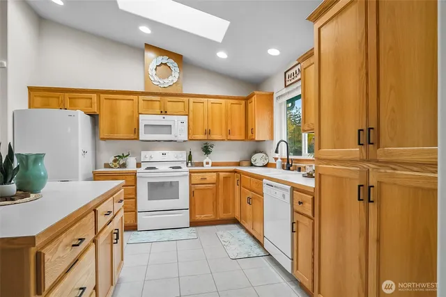 a kitchen with a stove a sink a refrigerator and cabinets