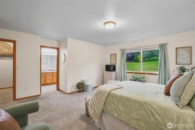 a bedroom with a bed and a painting on the wall