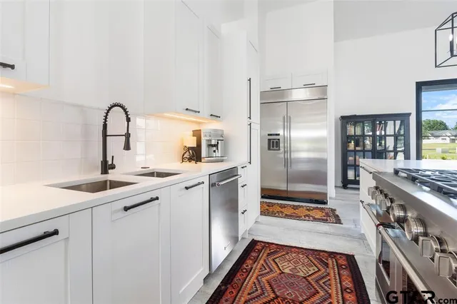 a kitchen with a sink stove and refrigerator