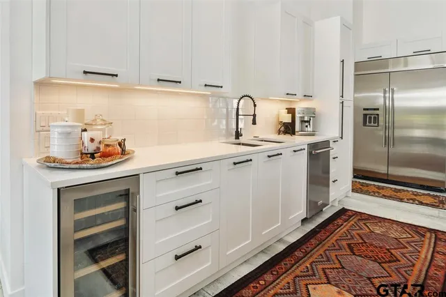 a kitchen with stainless steel appliances a stove and cabinets