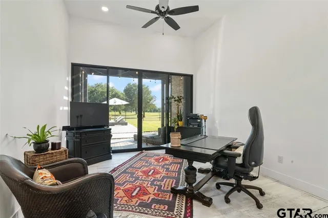 a work room with furniture and a potted plant