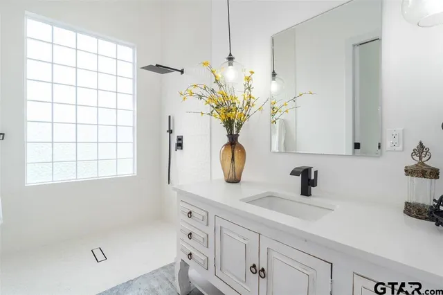 a bathroom with a sink a toilet and window