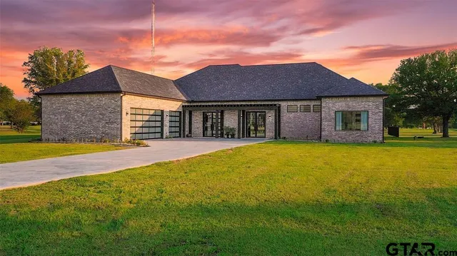 a view of a house with pool and a yard