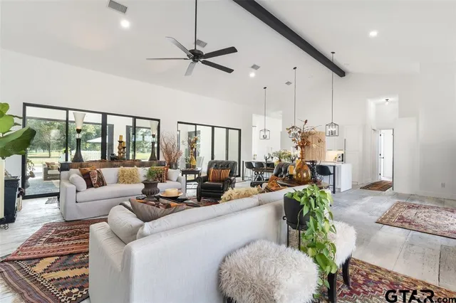a living room with furniture and a large window