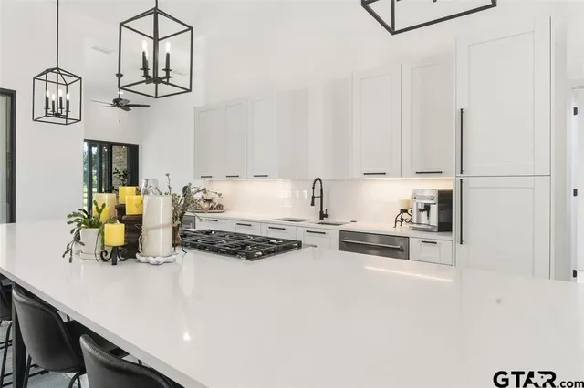 a kitchen with kitchen island cabinets and stainless steel appliances