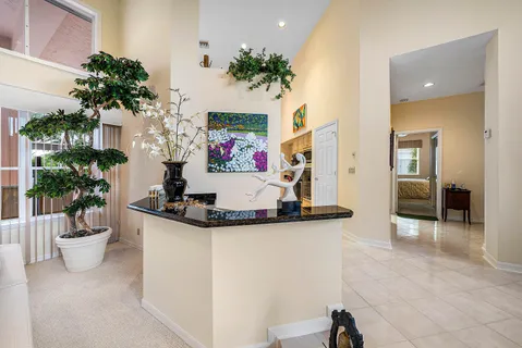 a kitchen with granite countertop a sink and cabinets