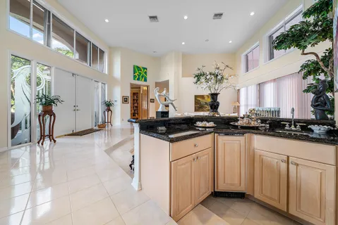 a kitchen with stainless steel appliances granite countertop a refrigerator and a stove