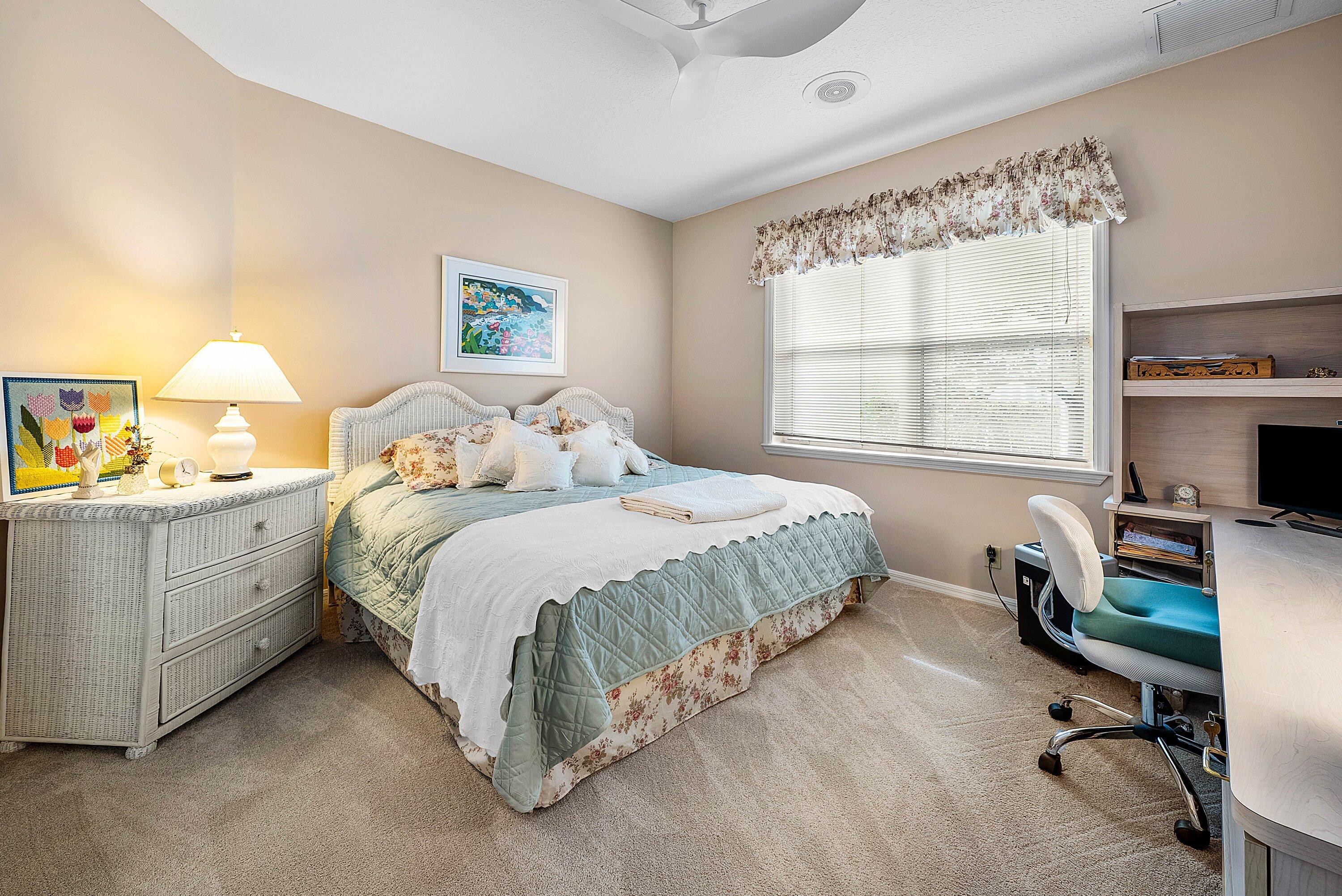 7142 Montrico Drive Boca Raton, FL 33433 - Photo 26 of 59 a bedroom with a bed and a desk