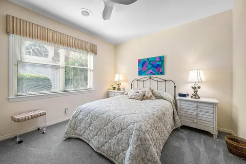 a bathroom with a granite countertop sink mirror vanity and toilet