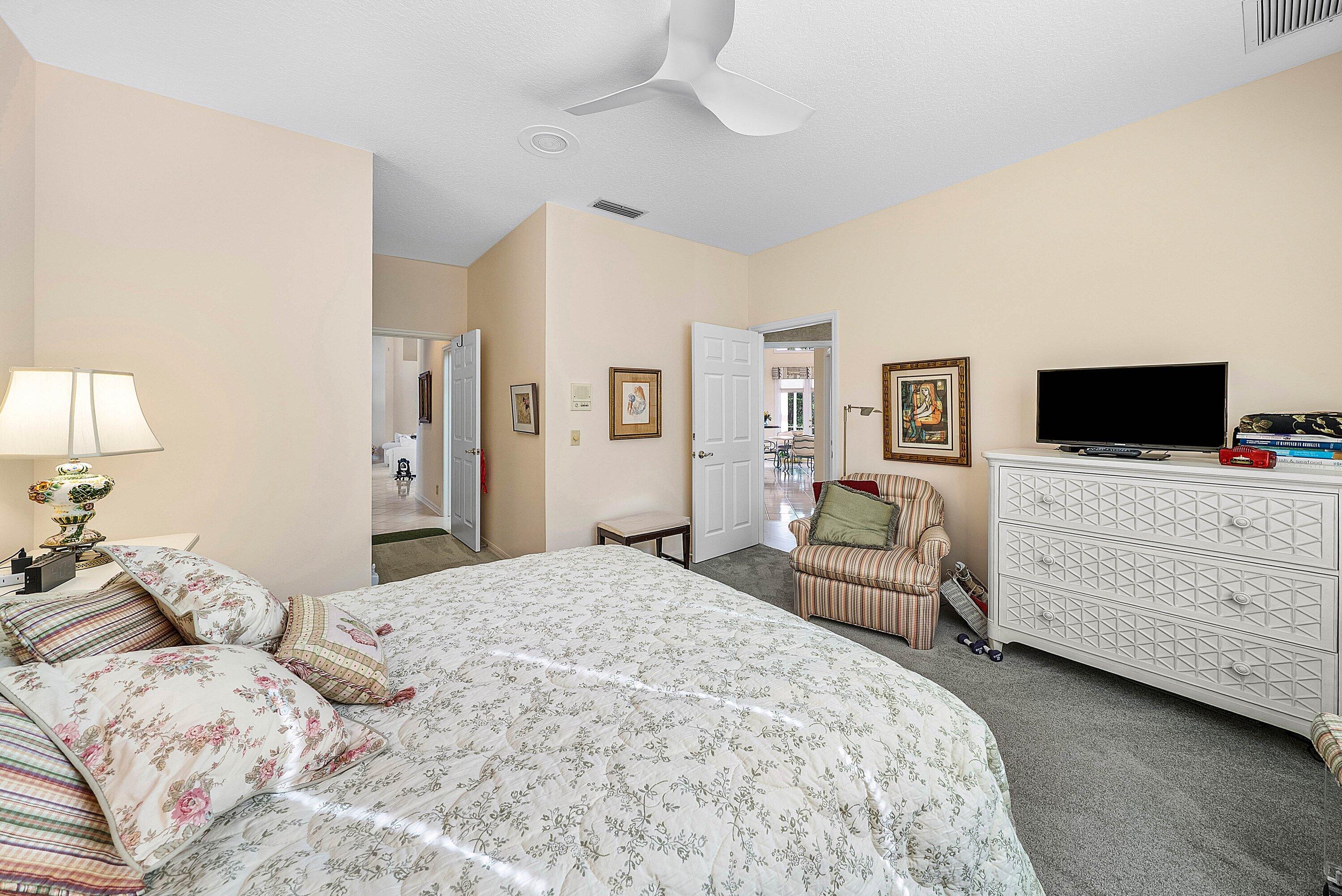 7142 Montrico Drive Boca Raton, FL 33433 - Photo 29 of 59 a bedroom with a bed and a flat screen tv