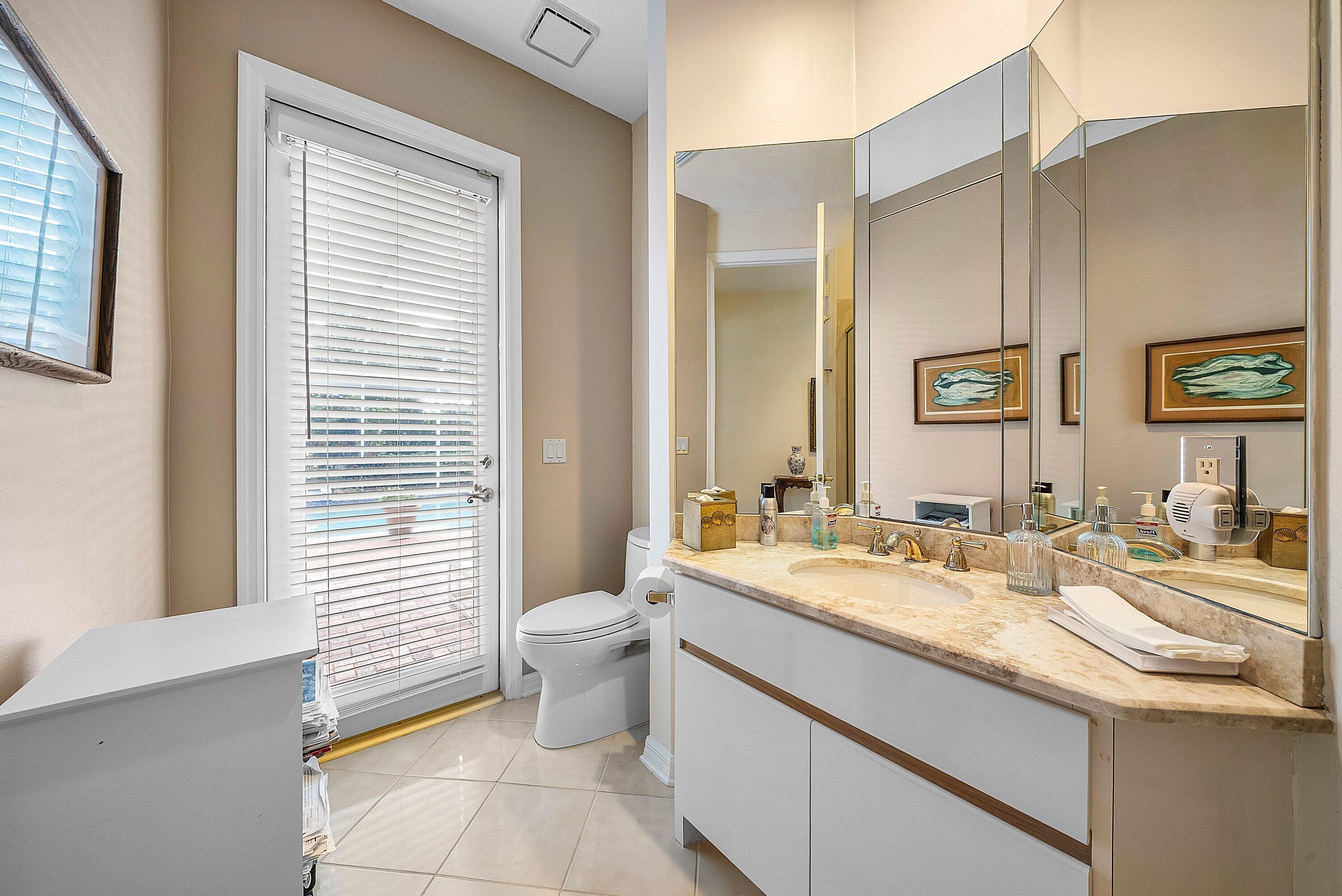 7142 Montrico Drive Boca Raton, FL 33433 - Photo 32 of 59 a bathroom with a granite countertop sink mirror vanity and toilet