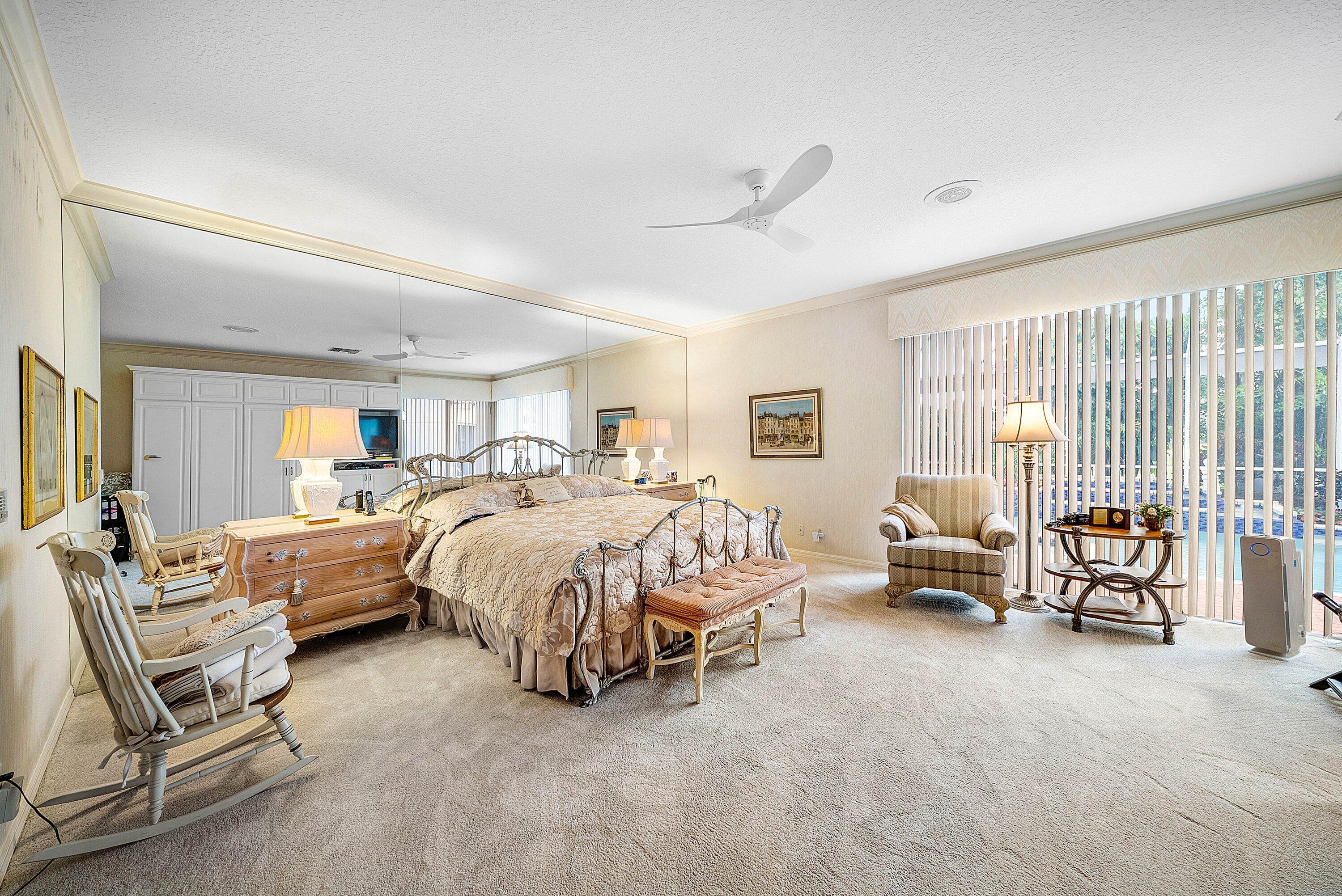 7142 Montrico Drive Boca Raton, FL 33433 - Photo 34 of 59 a spacious bedroom with a bed and a couch