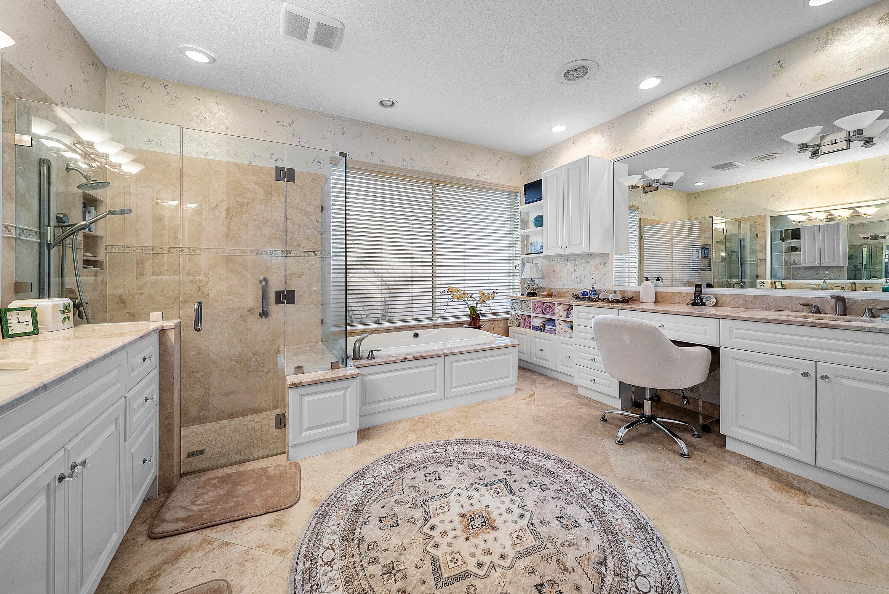 7142 Montrico Drive Boca Raton, FL 33433 - Photo 36 of 59 a large spacious bathroom with a double vanity sink mirror and a bathtub