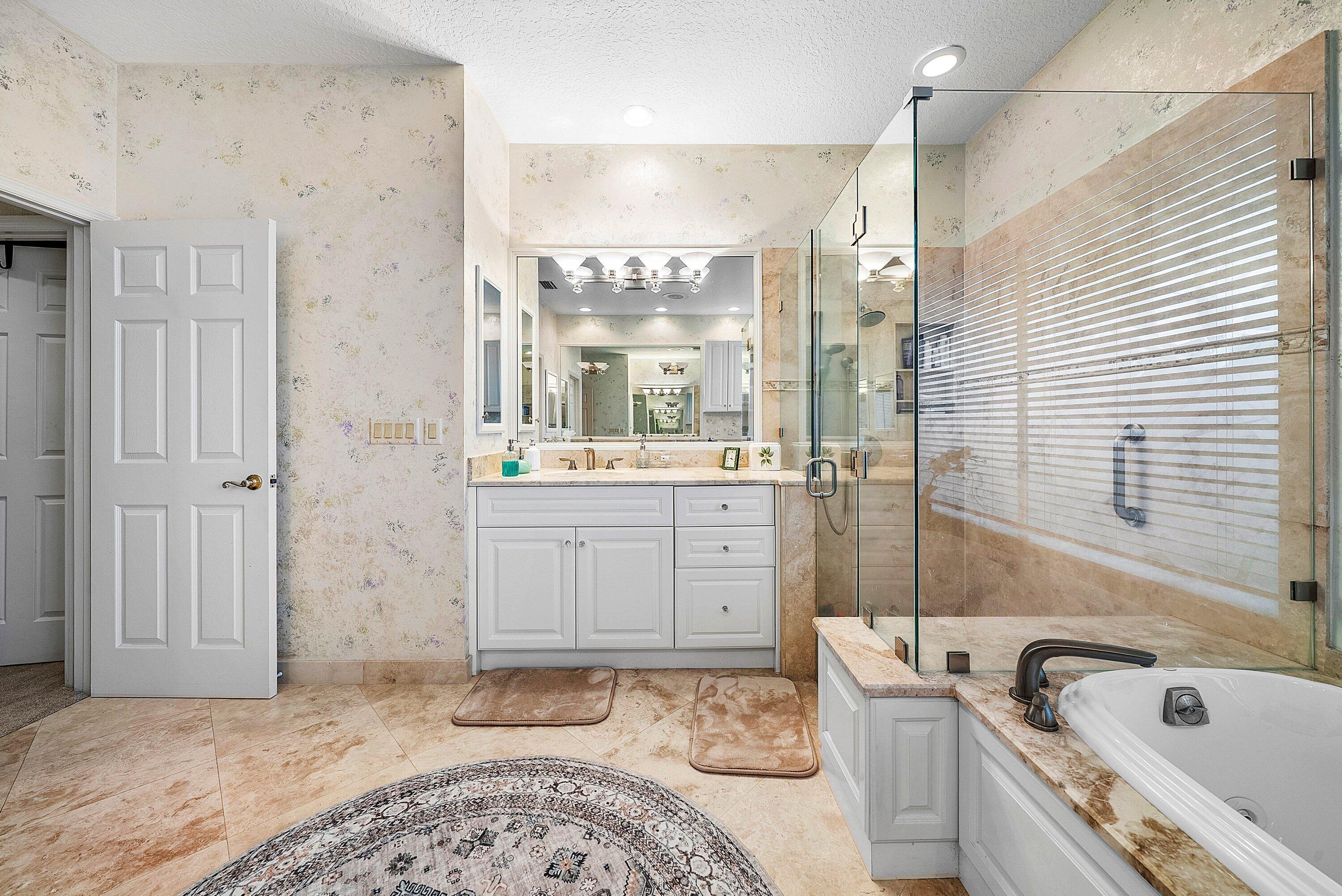 7142 Montrico Drive Boca Raton, FL 33433 - Photo 37 of 59 a bathroom with a tub sink and mirror