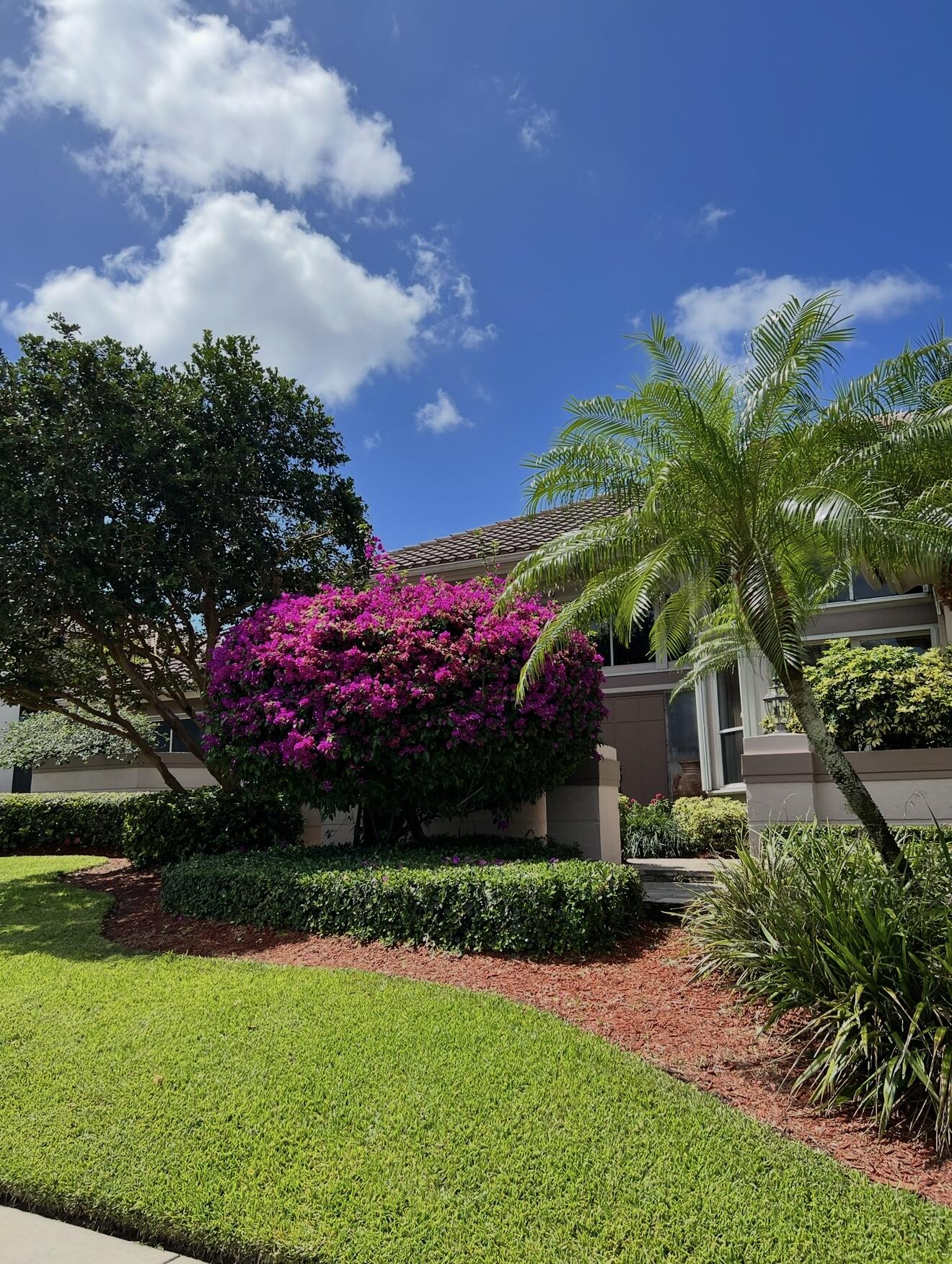 7142 Montrico Drive Boca Raton, FL 33433 - Photo 5 of 59 a front view of a house with garden
