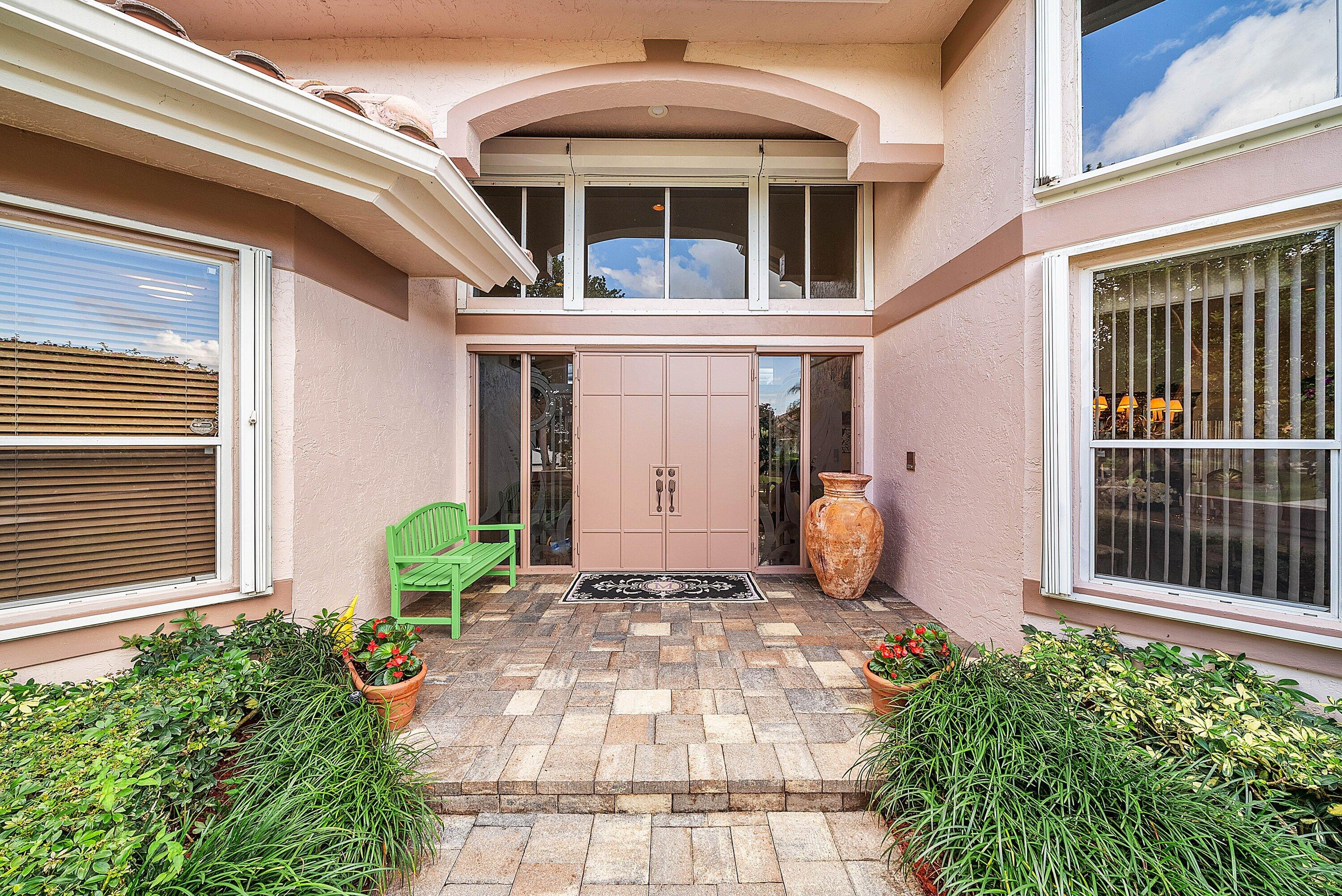 7142 Montrico Drive Boca Raton, FL 33433 - Photo 9 of 59 a front view of a house with a chairs and table in a patio