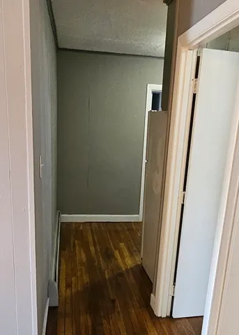 a view of washer and dryer with wooden cabinets