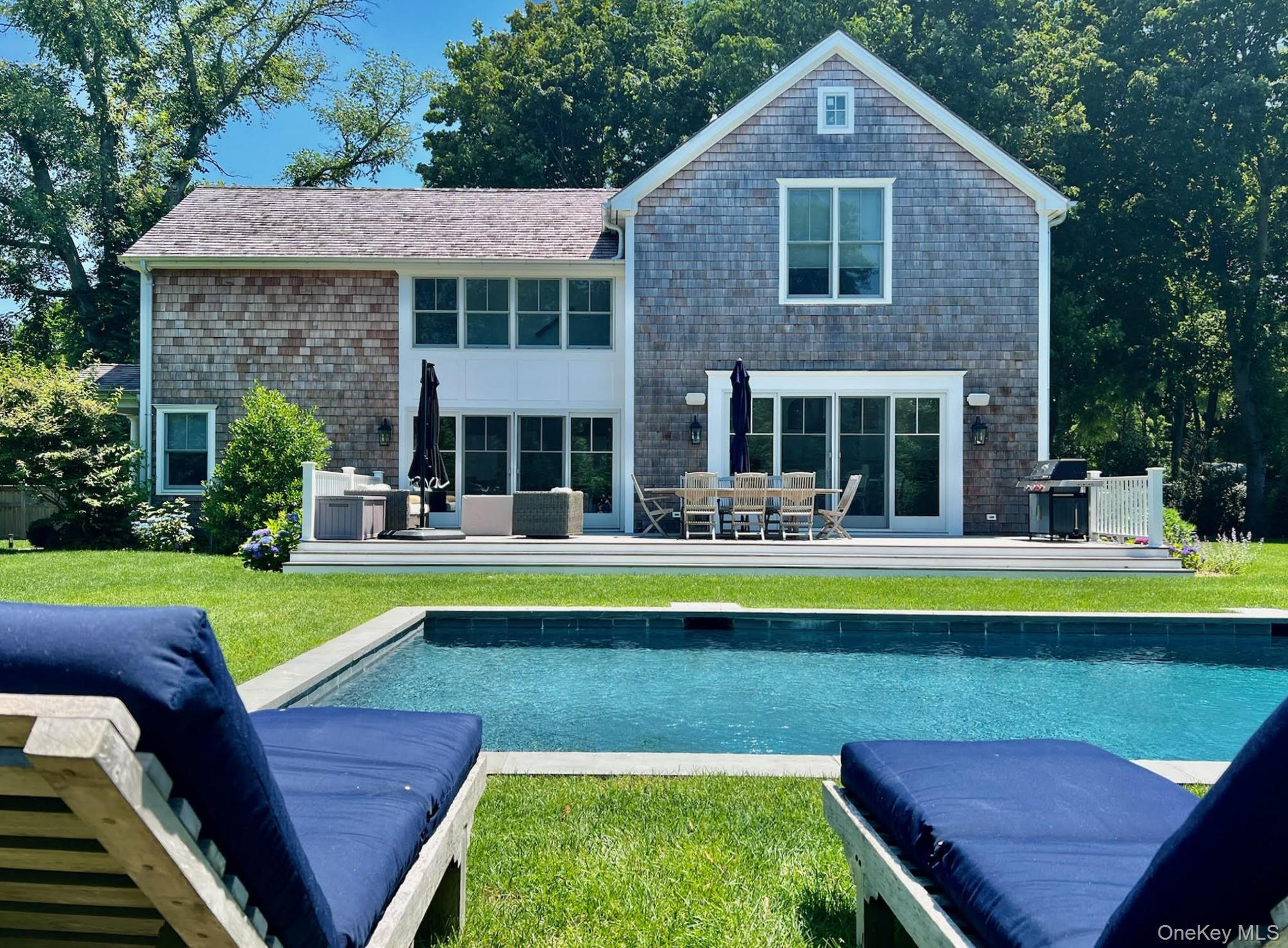 96 Miller Road Southampton, NY 11968 - Photo 16 of 18 a view of a house with swimming pool and a chairs