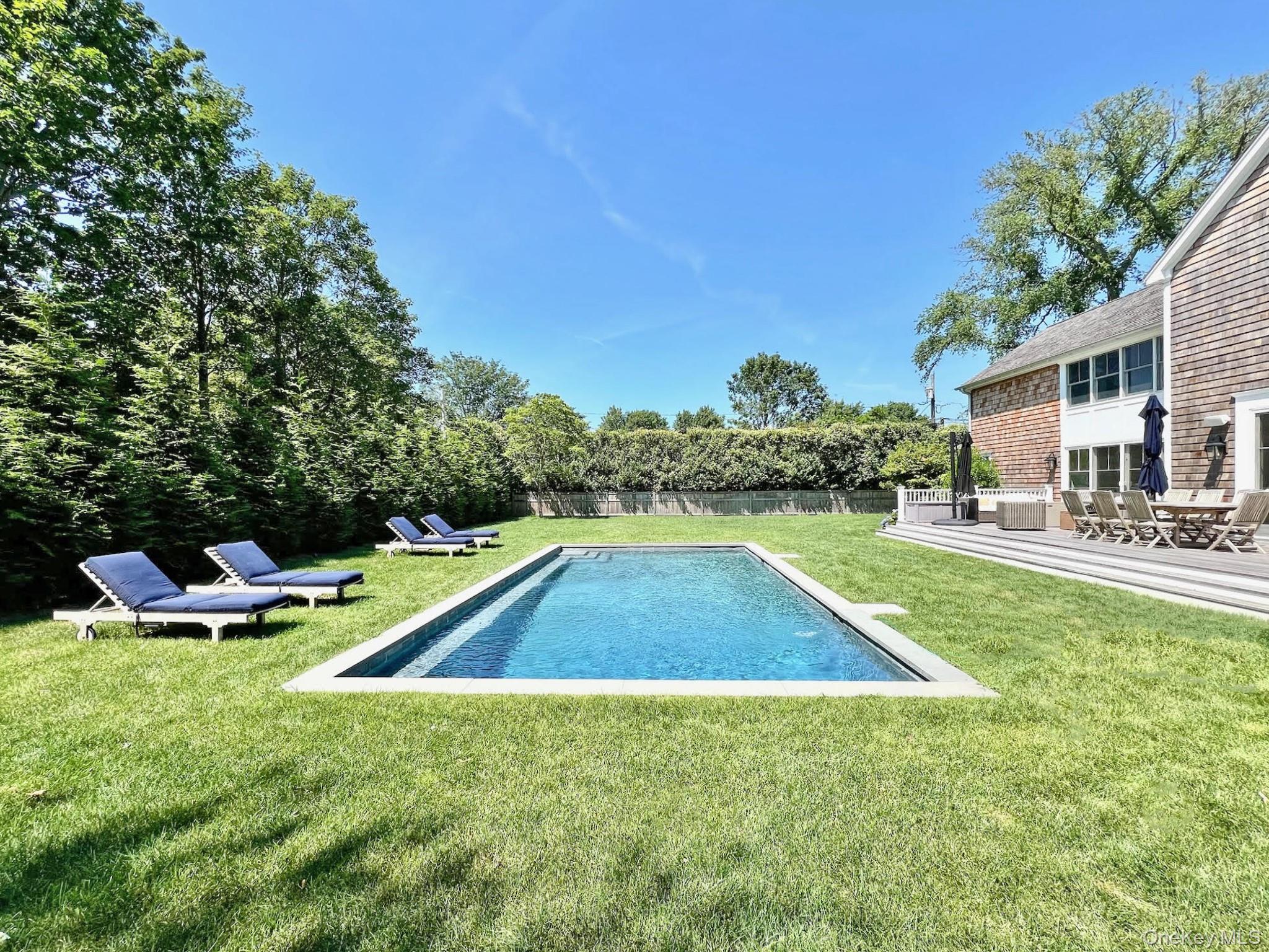 96 Miller Road Southampton, NY 11968 - Photo 17 of 18 a view of backyard with swimming pool and outdoor seating