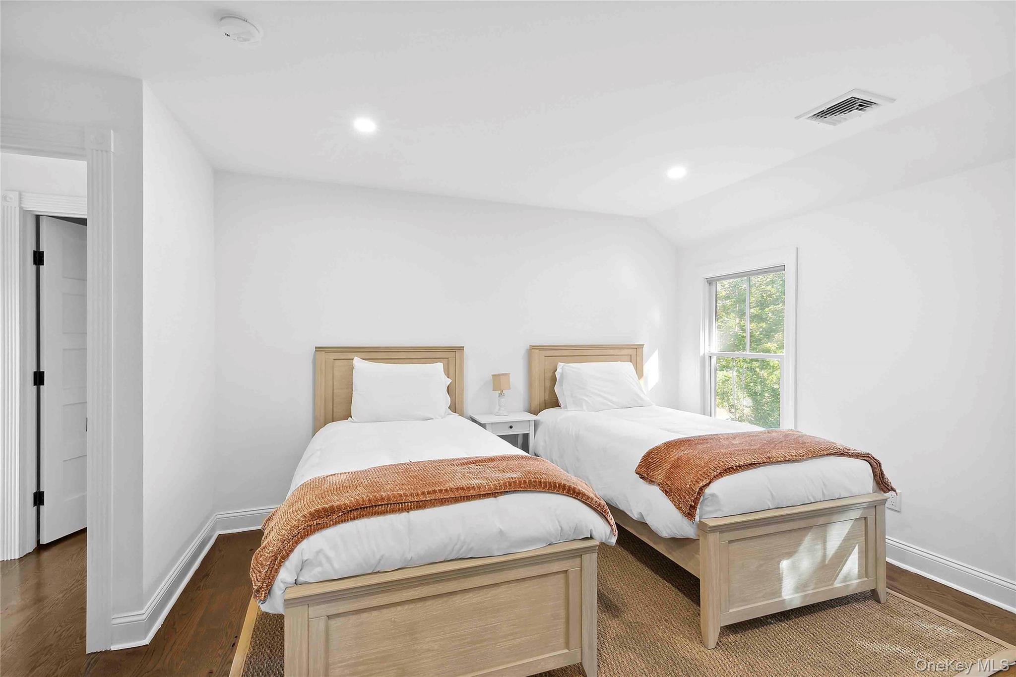 96 Miller Road Southampton, NY 11968 - Photo 6 of 18 a bedroom with two beds and a window