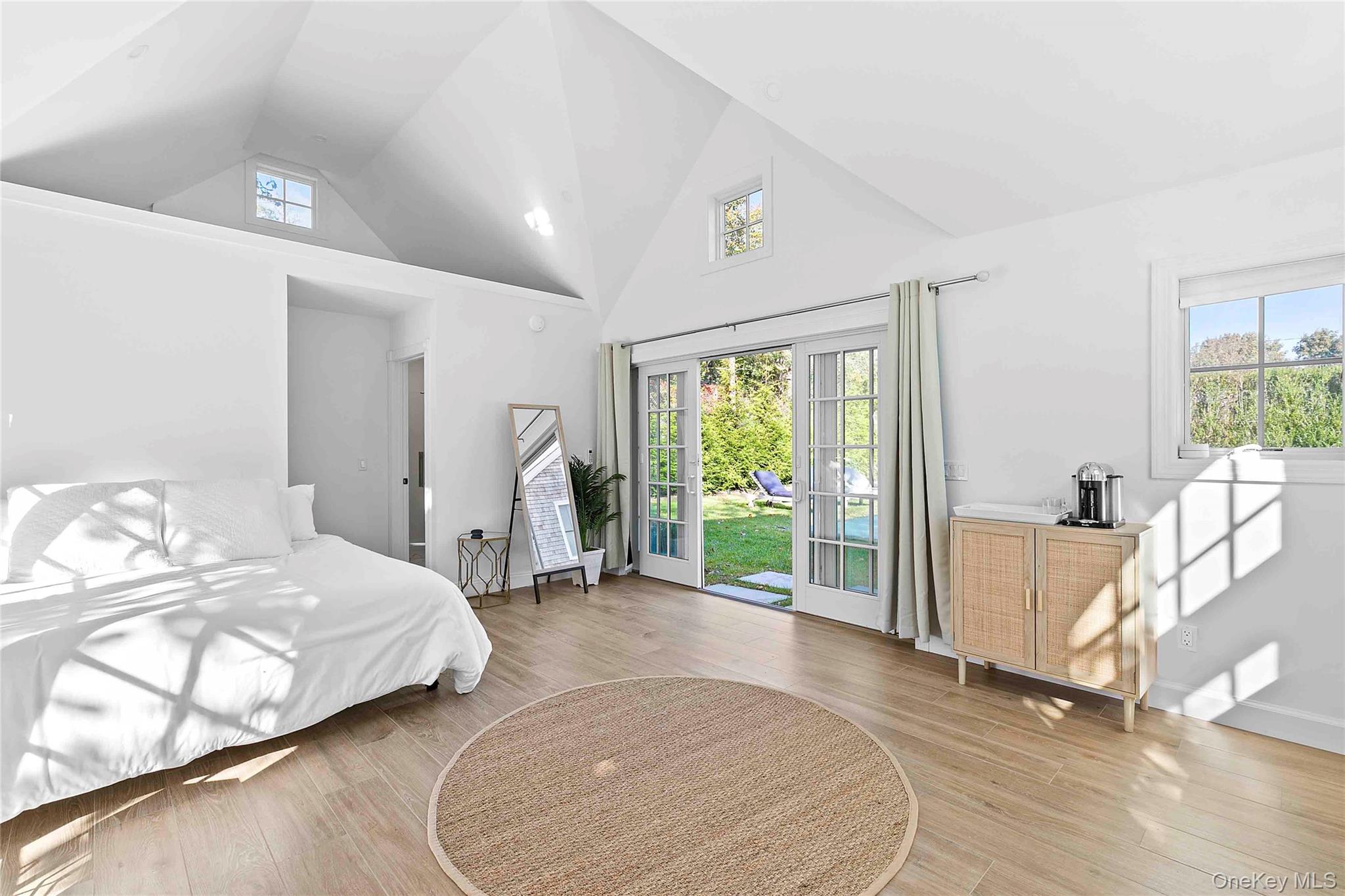 96 Miller Road Southampton, NY 11968 - Photo 9 of 18 a spacious bedroom with a bed and a large window