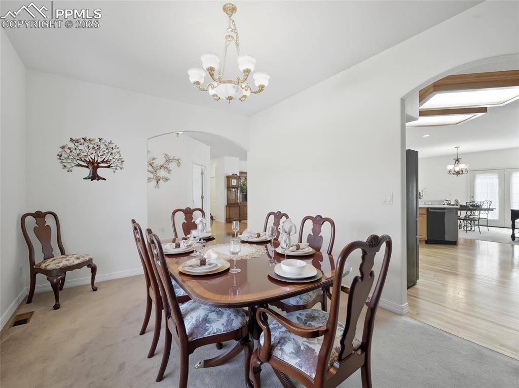 12855 Murphy Road Elbert, CO 80106 - Photo 12 of 50 a view of a dining room with furniture and chandelier