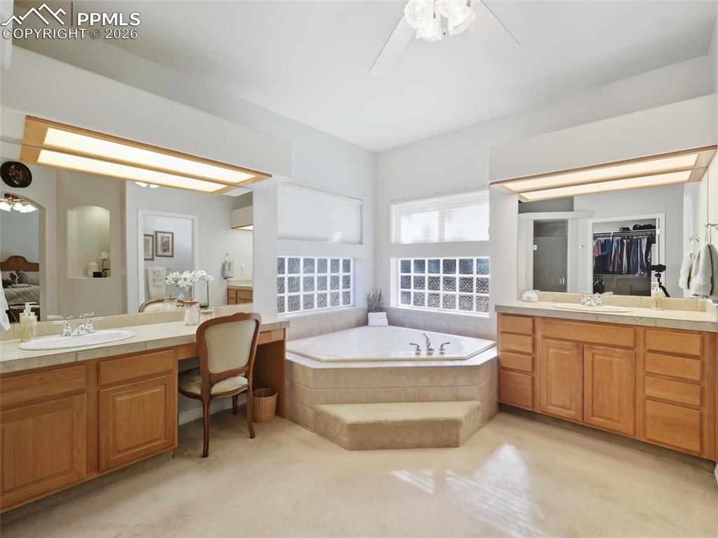 12855 Murphy Road Elbert, CO 80106 - Photo 16 of 50 a spacious bathroom with a double vanity sink mirror and bathtub