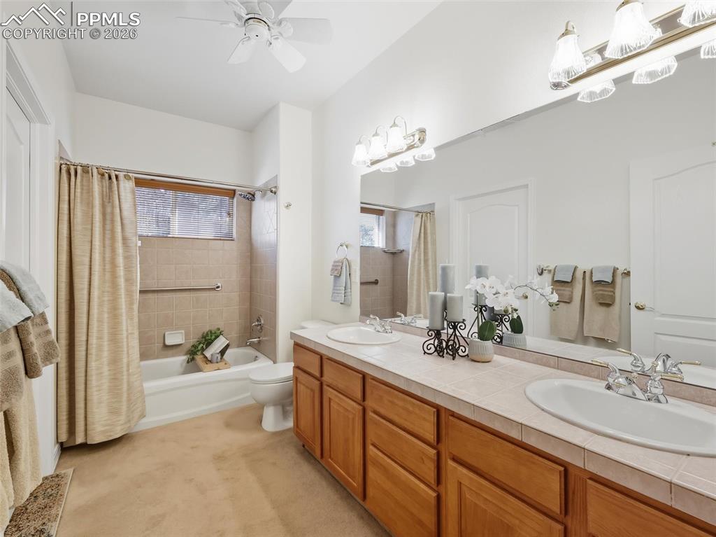 12855 Murphy Road Elbert, CO 80106 - Photo 20 of 50 a spacious bathroom with a double vanity sink a mirror a bathtub and shower