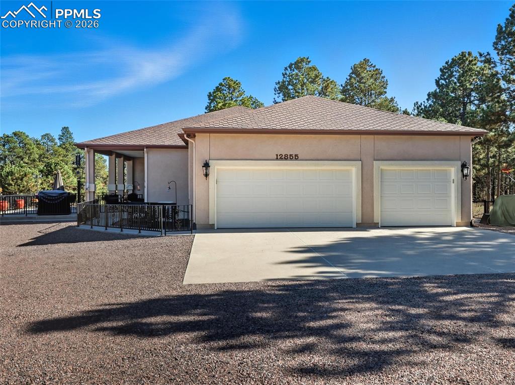 12855 Murphy Road Elbert, CO 80106 - Photo 2 of 50 a front view of a house with a yard and garage