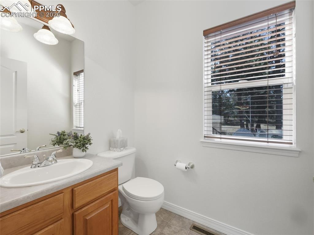 12855 Murphy Road Elbert, CO 80106 - Photo 22 of 50 a bathroom with a sink a toilet and mirror