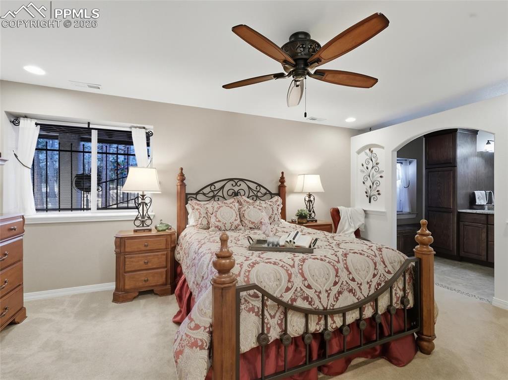 12855 Murphy Road Elbert, CO 80106 - Photo 29 of 50 a bedroom with a bed and a chandelier