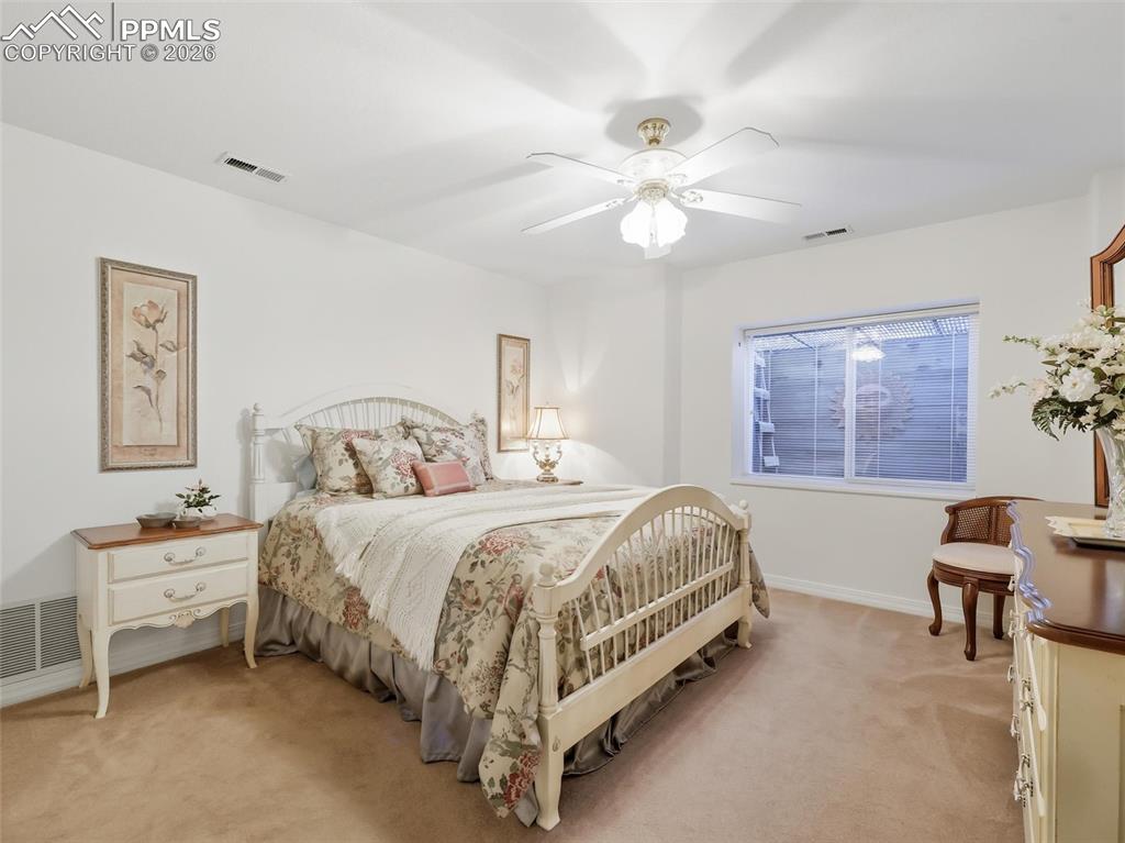 12855 Murphy Road Elbert, CO 80106 - Photo 35 of 50 a spacious bedroom with a bed and a chandelier