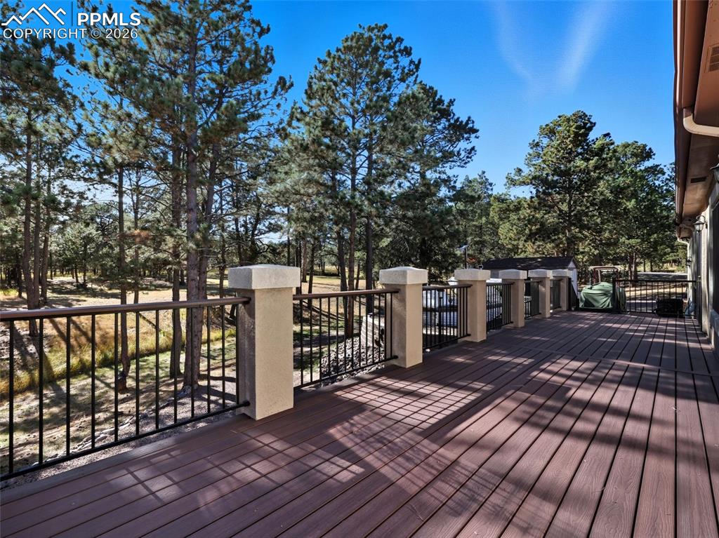 12855 Murphy Road Elbert, CO 80106 - Photo 37 of 50 a view of a deck with wooden floor and fence next to a yard