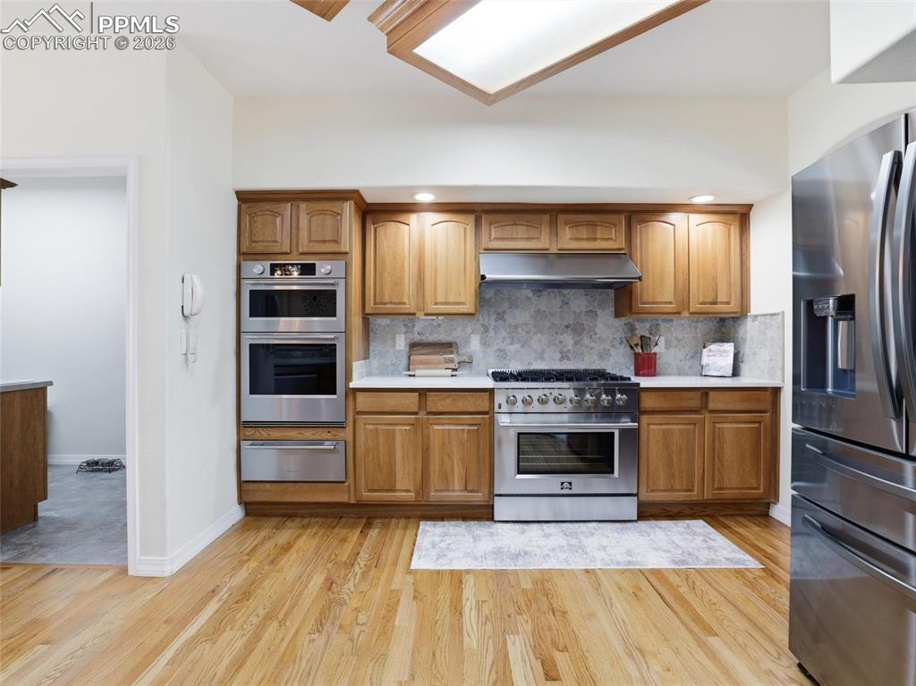 12855 Murphy Road Elbert, CO 80106 - Photo 6 of 50 a kitchen with stainless steel appliances granite countertop a refrigerator and a stove top oven