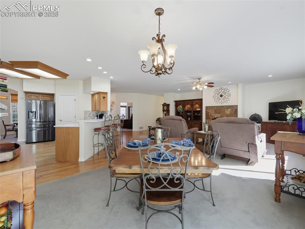 12855 Murphy Road Elbert, CO 80106 - Photo 9 of 50 a living room with furniture kitchen view and a chandelier