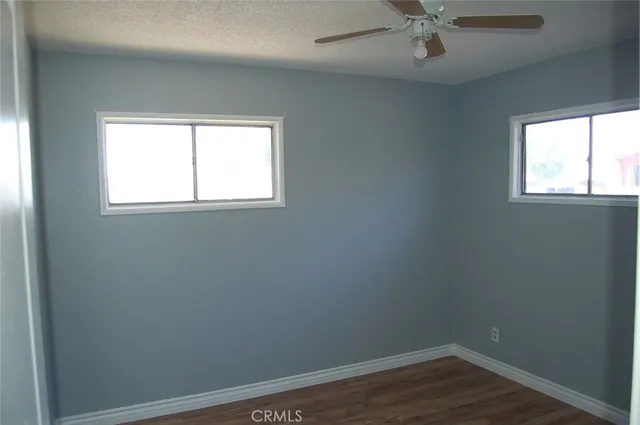 a view of a small space with wooden floor and a window