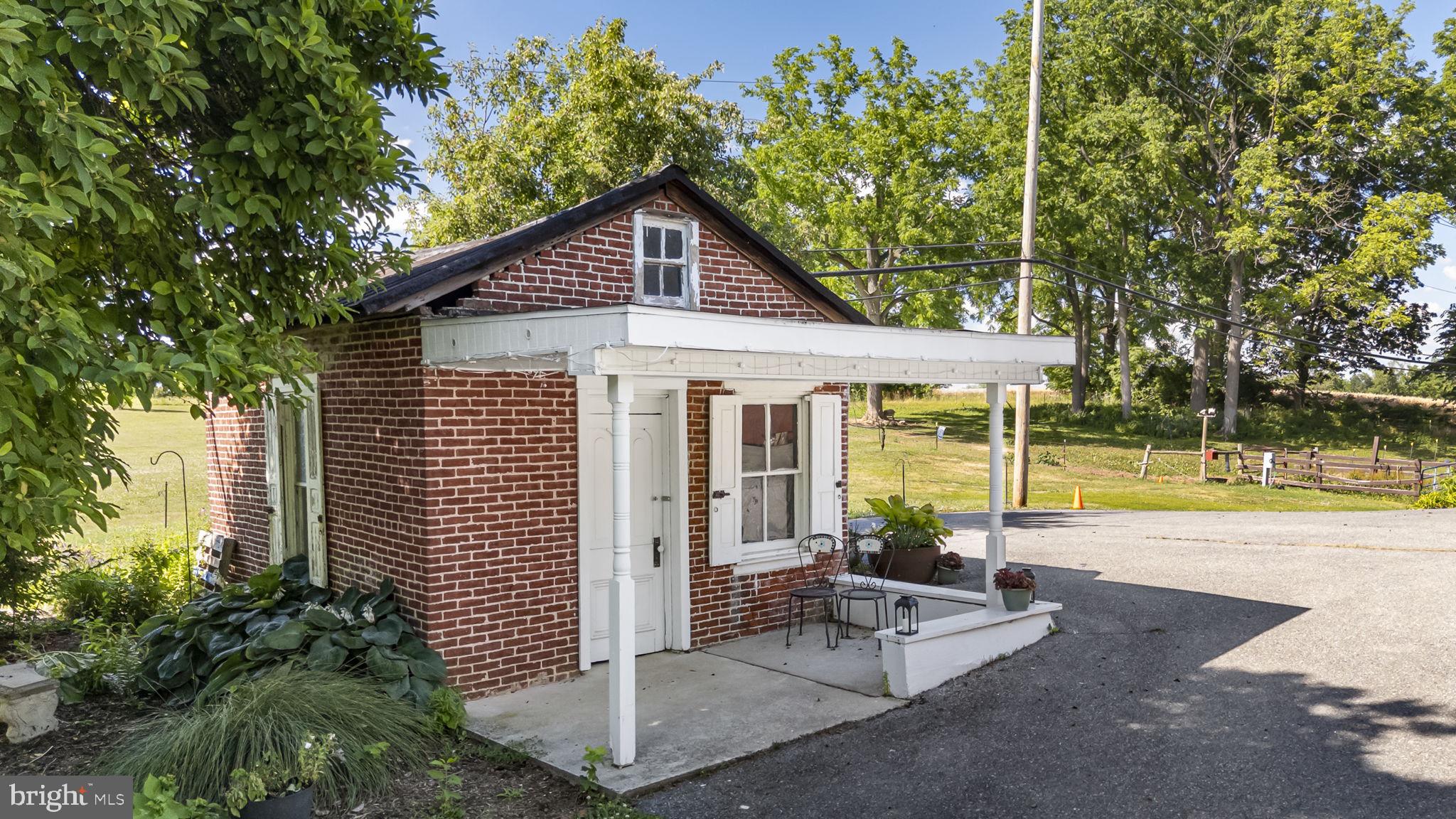 416 Snyder Road Reading, PA 19605 - Photo 52 of 63 Charming brick cottage with lush greenery.