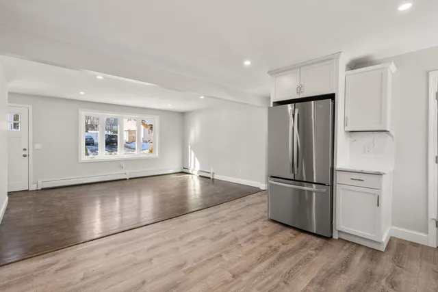 a view of a refrigerator in kitchen and wooden floor