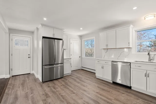 a kitchen with stainless steel appliances a refrigerator sink and microwave