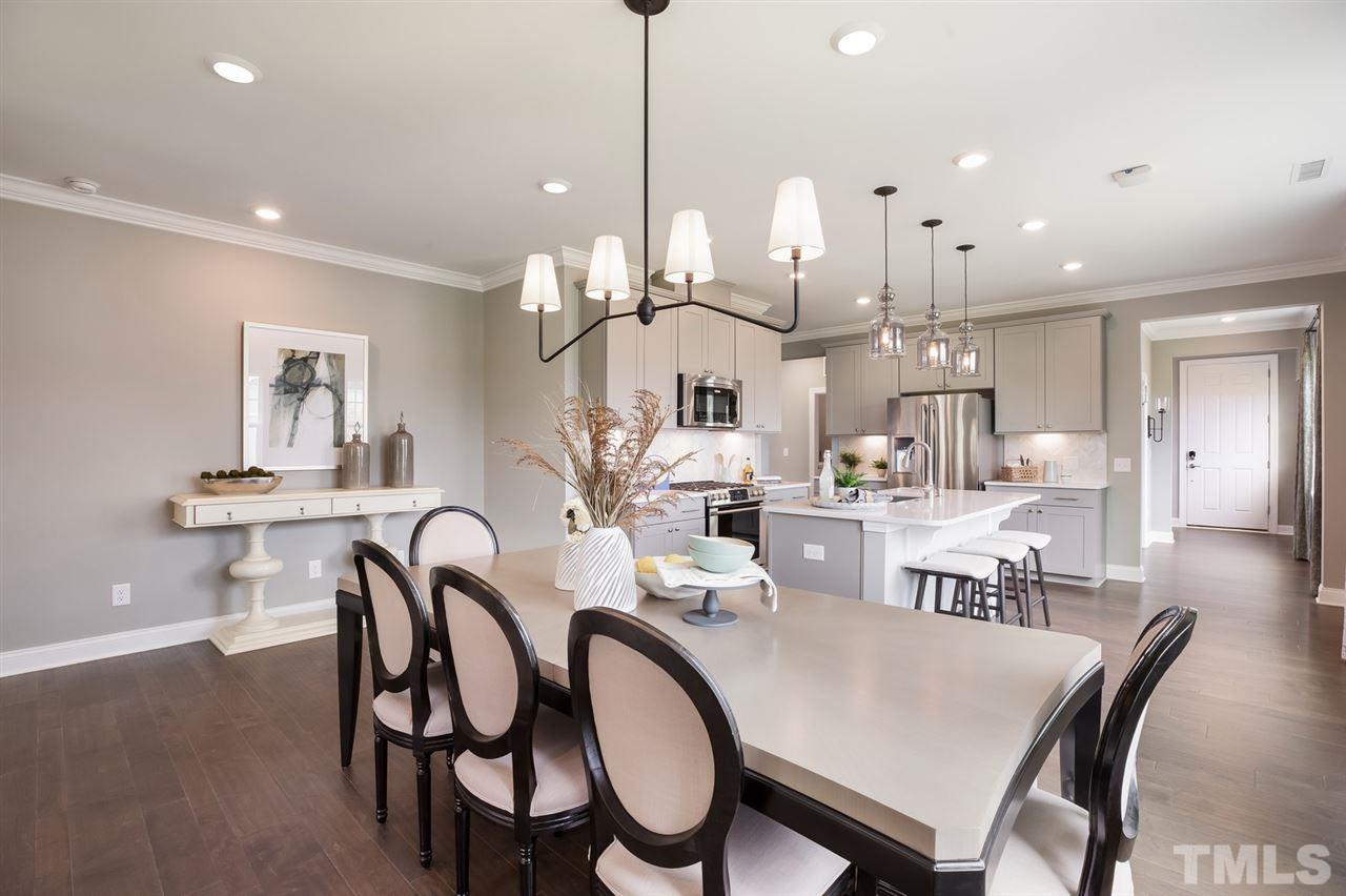 244 Mahogany Run, Unit 192 Raleigh, NC 27610 - Photo 18 of 30 a large kitchen with a table and chairs