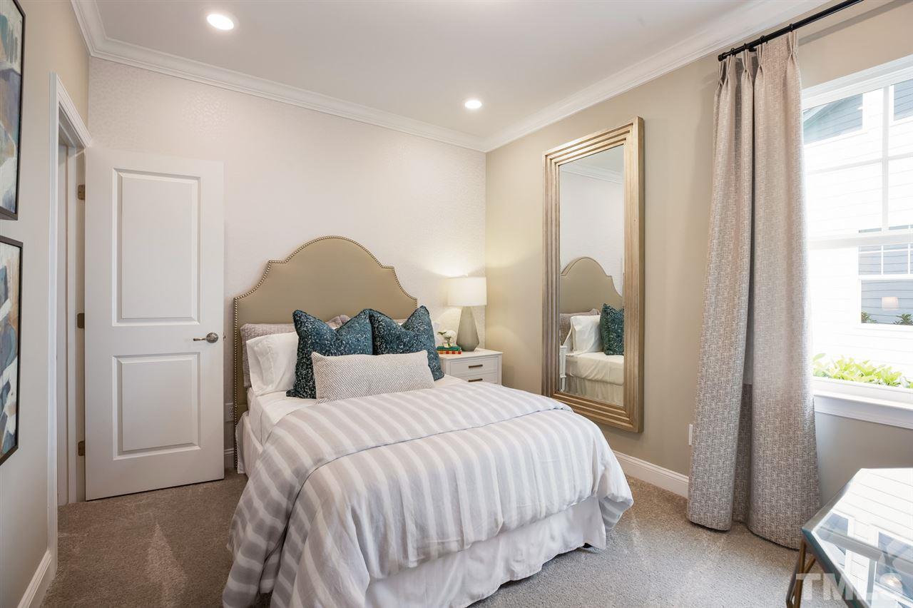 244 Mahogany Run, Unit 192 Raleigh, NC 27610 - Photo 25 of 30 a bedroom with a bed and a window