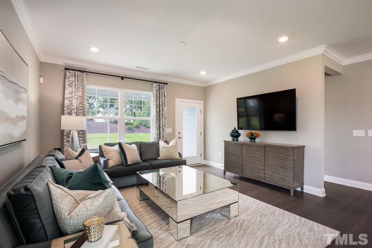 244 Mahogany Run, Unit 192 Raleigh, NC 27610 - Photo 10 of 30 a living room with furniture and a flat screen tv