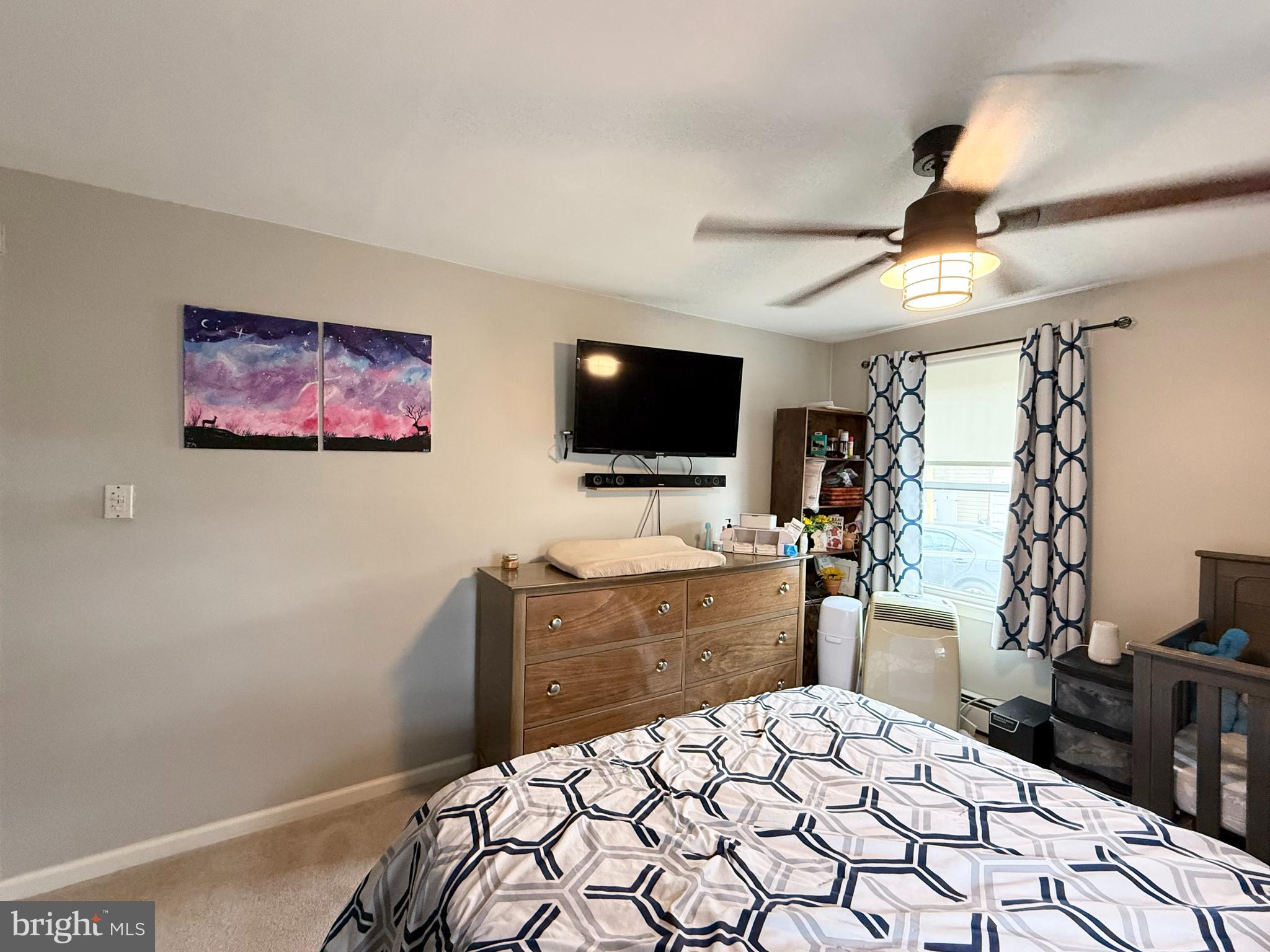 12 North Maple Avenue Ridgely, MD 21660 - Photo 11 of 23 a bedroom with a bed and a flat screen tv