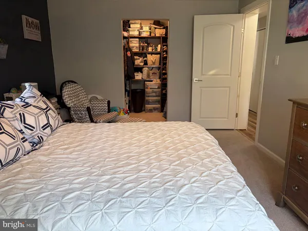 a large bed sitting in a bedroom next to a cabinet