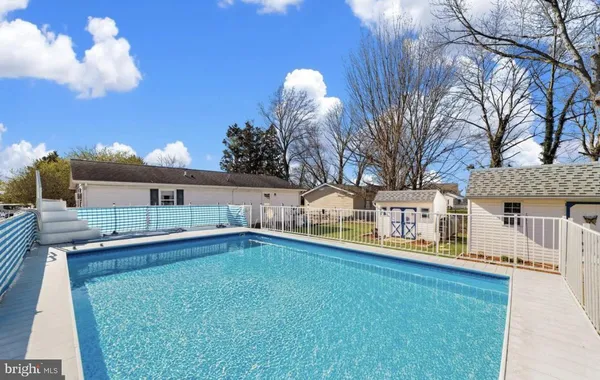 a view of a house with a backyard and a fire pit