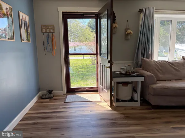 a view of a livingroom with furniture and a floor to ceiling window
