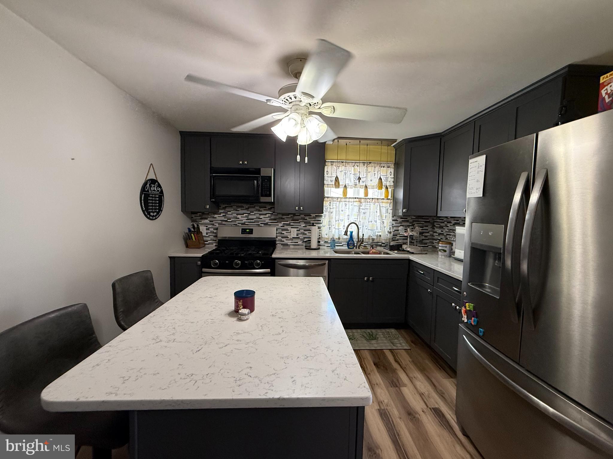 12 North Maple Avenue Ridgely, MD 21660 - Photo 6 of 23 a kitchen with kitchen island a sink stainless steel appliances and cabinets