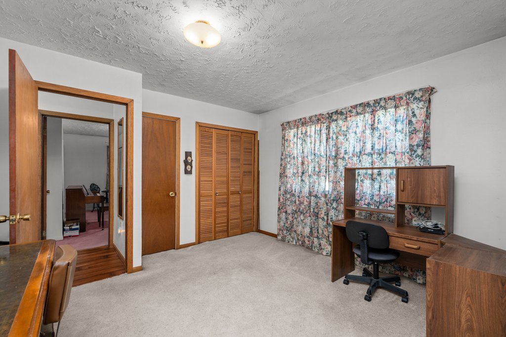 11213 22nd Street Milan, IL 61264 - Photo 13 of 36 a view of a livingroom with workspace and a window